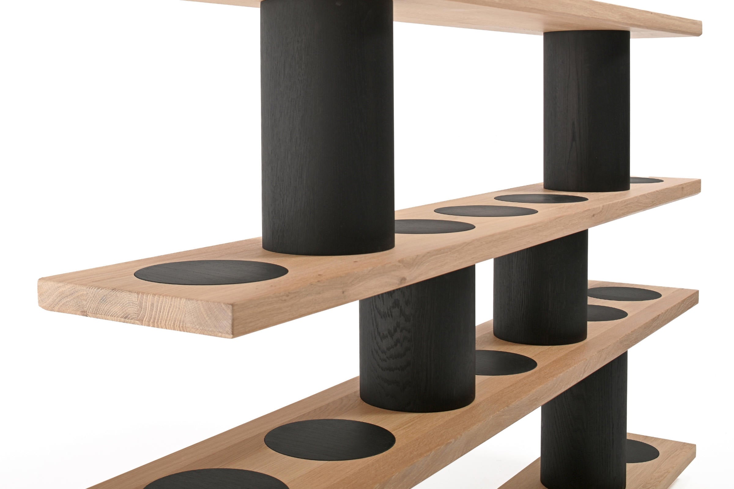 Kontraste zwischen heller Eiche und schwarzen Formen des Bücherregals