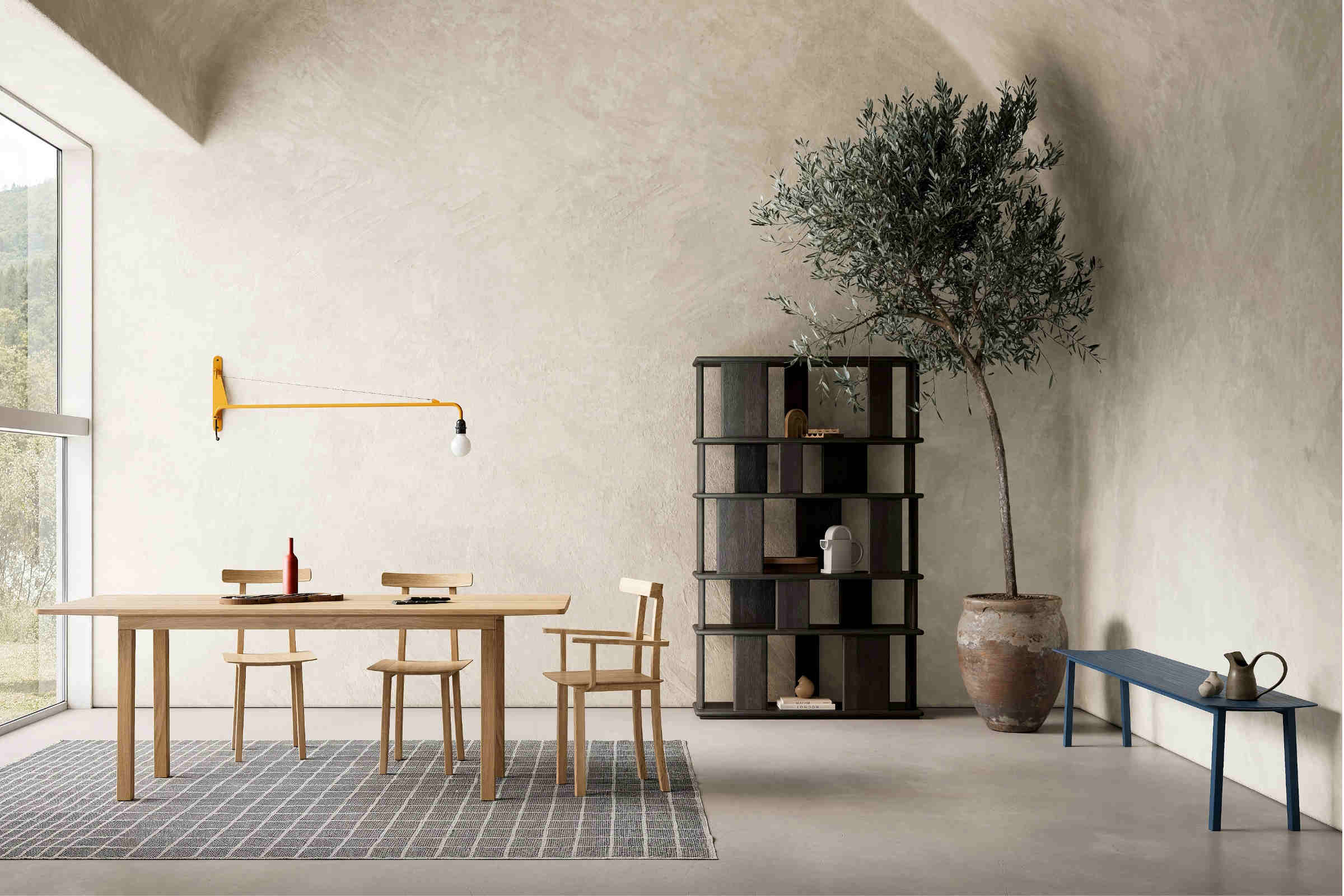 Designer-Esstisch von Woak in modernem Ambiente mit Bücherregal, Stühlen und einer Sitzbank